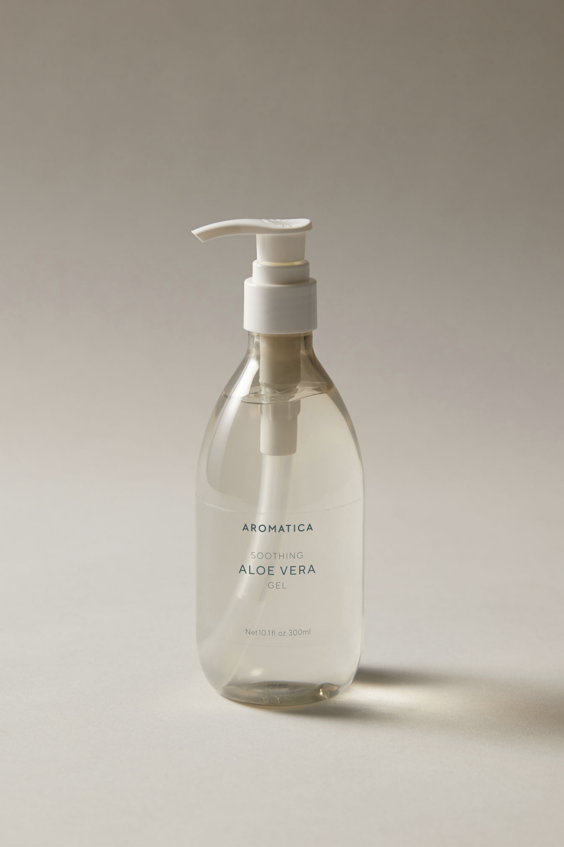 Bottle of Aromatica Organic Aloe Vera Gel against a soft grey background.