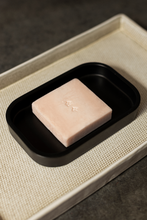 Load image into Gallery viewer, Ondo Beauty 36.5&#39;s Calamine &amp; Oatmeal Soothing Cleansing Bar sitting on a black soap holder which is sitting on a beige tray. Available for purchase at Sinless Skincare.
