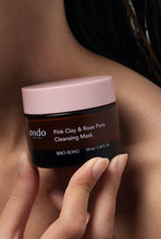 Load image into Gallery viewer, Close up of a woman holding a jar of Ondo Beauty&#39;s Pink Clay &amp; Rose Pore Cleansing Mask against her shoulder and neck. Available for purchase at Sinless Skincare.
