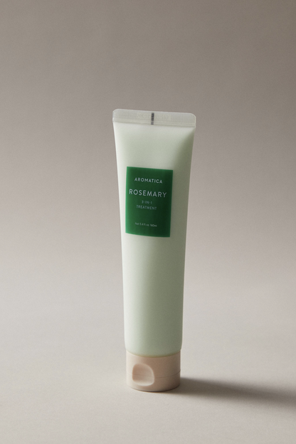 Bottle of Aromatica's Rosemary 3-in-1 Treatment against a soft grey background