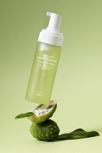 Load image into Gallery viewer, Capless bottle of Purito&#39;s Clear Code Superfruit Cleanser on top of two pieces of Noni fruit, against a light green background. Available for purchase at Sinless Skincare.
