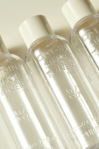 Closeup shot of empty bottles of Purito's Oat-in Silky Toner. Available for purchase at Sinless Skincare.