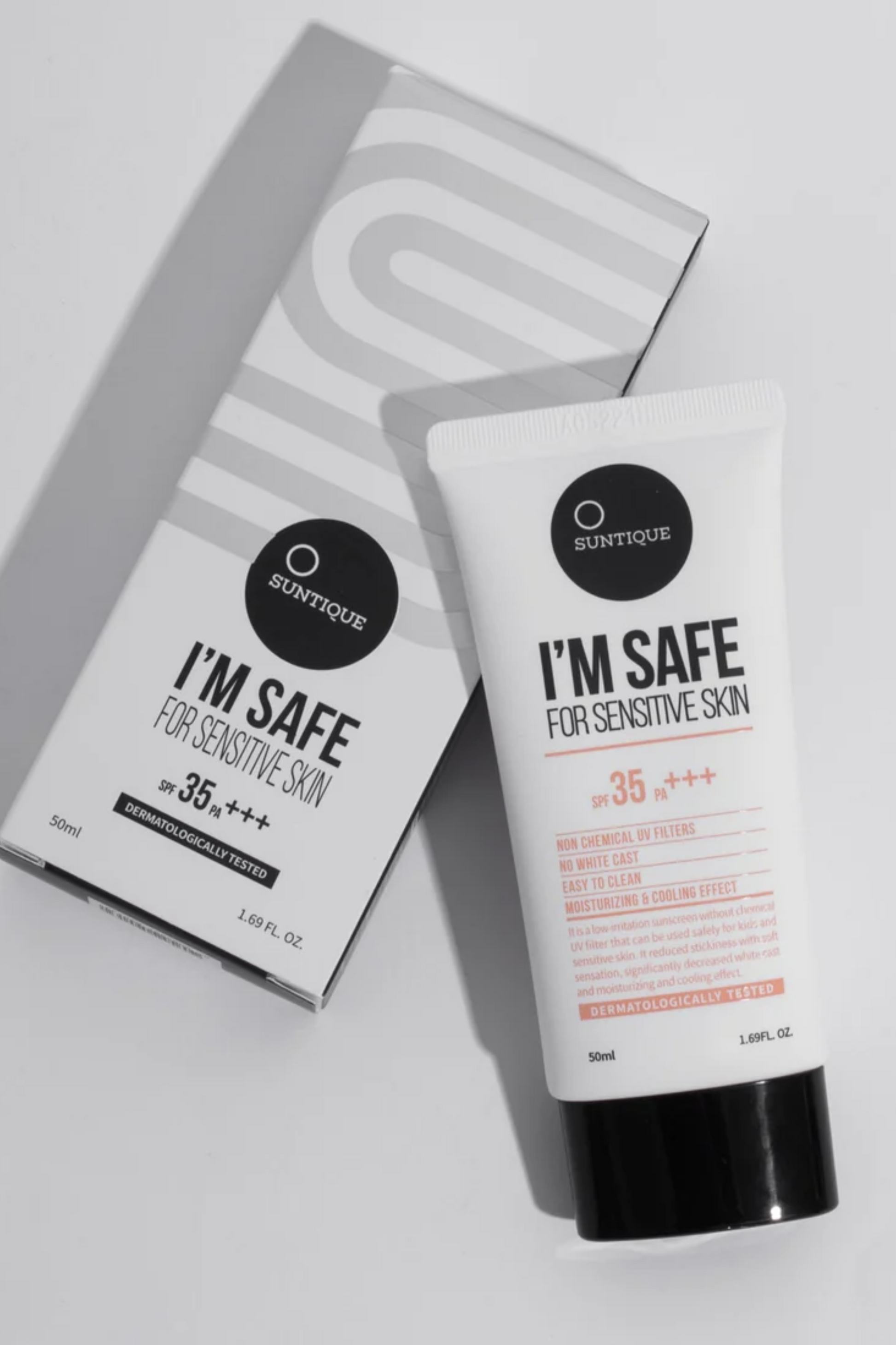 Tube of Suntique's I'm Safe for Sensitive Skin SPF laying face up on its box. Photo taken from above. Available for purchase at Sinless Skincare.