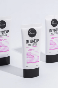 Three tubes of Suntique's I'm Tone Up Multibase sunscreen standing in a triangle formation against a white background. Available for purchase at Sinless Skincare.