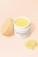 Load image into Gallery viewer, Open jar of Ondo Beauty&#39;s Multiacids &amp; Papaya Melting Cleansing Balm with orange lid leaning up against it. Some balm is on the ground in front of the jar. Light peach background.
